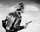 Rear view of a cowboy holding a pistol poster print.