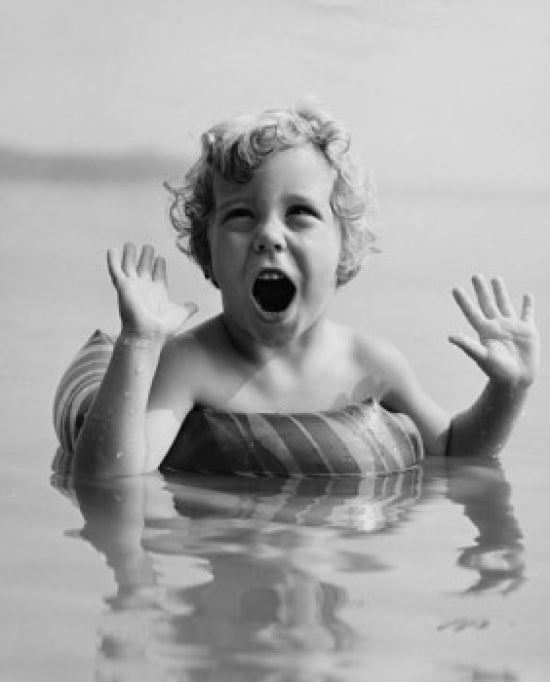 Close-up of a girl swimming with an inflatable ring poster print.