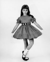 Studio portrait of a girl holding a dress, poster print.