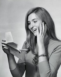 Close-up poster print of a teenage girl smiling while reading a letter.