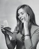 Close-up poster print of a teenage girl smiling while reading a letter.