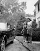 Mother and her children waving to their father poster print