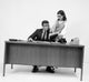 Businesswoman showing a file to a businessman poster print.