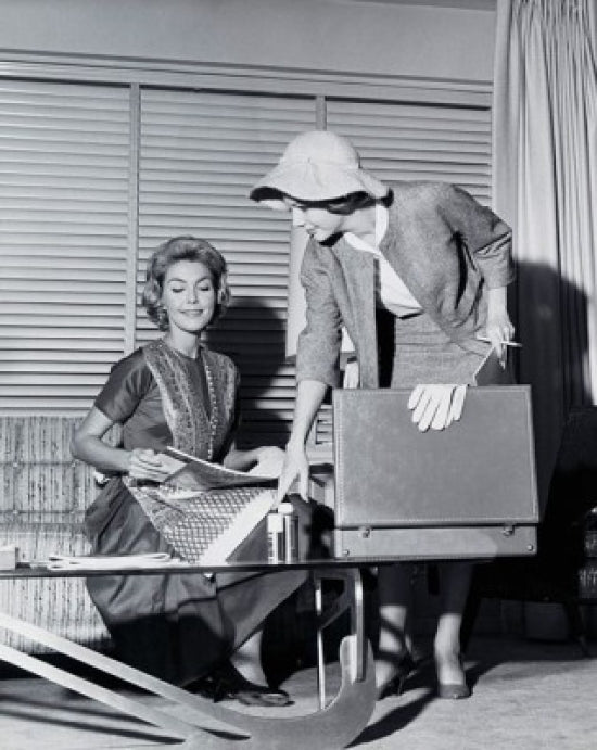 Saleswoman showing products to a young woman poster print
