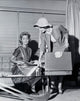 Saleswoman showing products to a young woman poster print