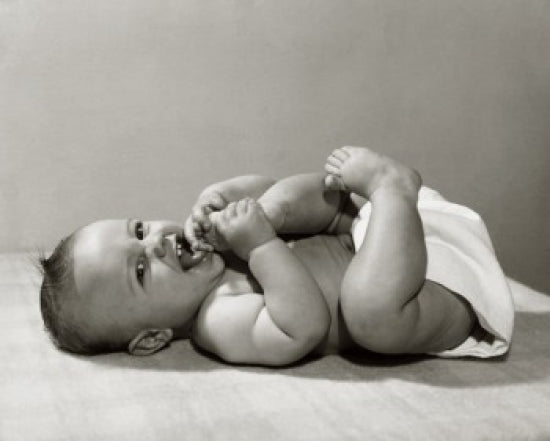 Close-up poster print of a baby lying on the floor