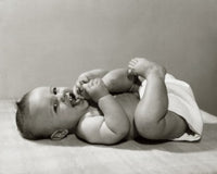Close-up poster print of a baby lying on the floor
