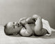 Close-up poster print of a baby lying on the floor