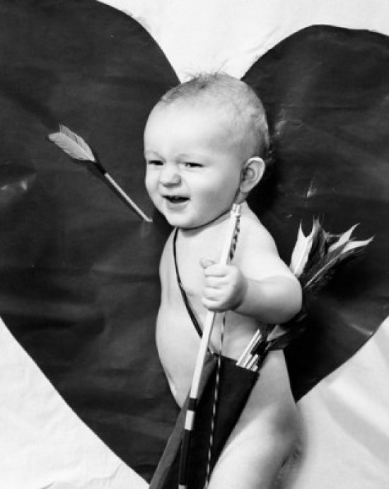 Poster of a side profile of a baby boy holding a bow and arrow