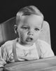 Close-Up of a Baby Sitting in a High Chair Poster Print