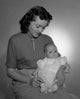 Young woman holding baby girl poster print showcasing maternal love.