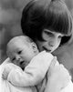 Young Mother Carrying Baby Poster Print capturing a tender moment of motherhood.