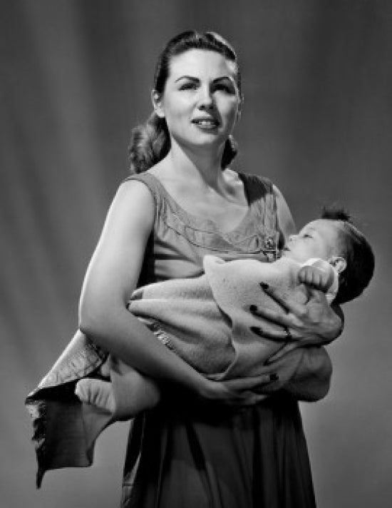 Portrait of mother carrying baby wrapped in blanket poster print.