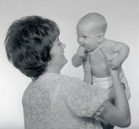 Mature woman holding baby poster print showcasing love and tenderness.