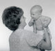 Mature woman holding baby poster print showcasing love and tenderness.