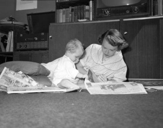 Mother and baby reading newspapers on the floor poster print