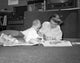 Mother and baby reading newspapers on the floor poster print