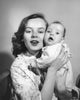 Portrait of mother and baby cheek to cheek poster print, showcasing a loving bond.