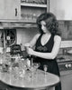 Young woman opening a wine bottle poster print, perfect for home decor.
