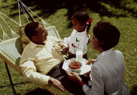 Family Bonding in Nature Poster Print featuring a couple and their daughter in a hammock.
