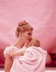 Close-up poster print of a woman carrying her son, showcasing love and affection.