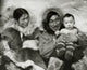 Eskimo couple sitting with their son poster print