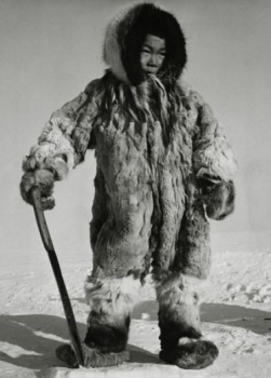 Eskimo boy standing on ice holding a knife poster print