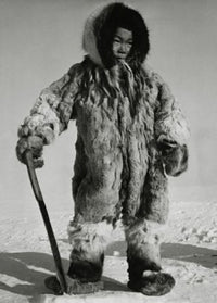 Eskimo boy standing on ice holding a knife poster print