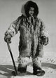 Eskimo boy standing on ice holding a knife poster print