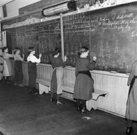 Students solving math problems on a blackboard poster print.