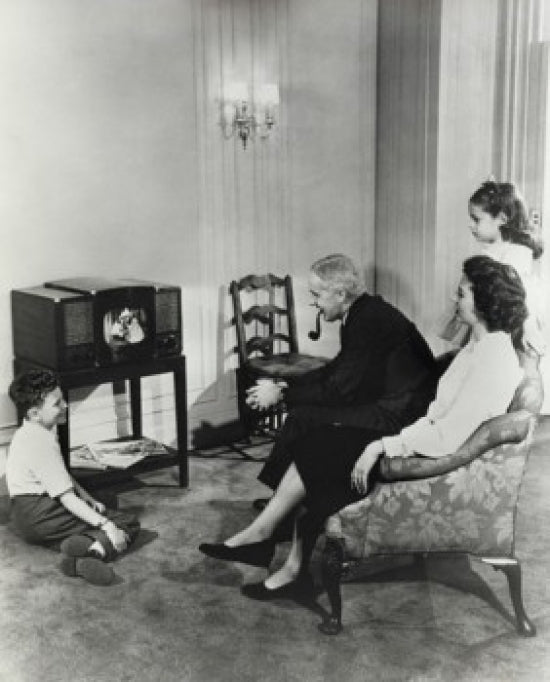 Family Watching Television at Home Poster Print featuring a cozy family scene.