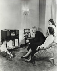 Family Watching Television at Home Poster Print featuring a cozy family scene.