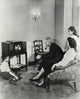 Family Watching Television at Home Poster Print featuring a cozy family scene.