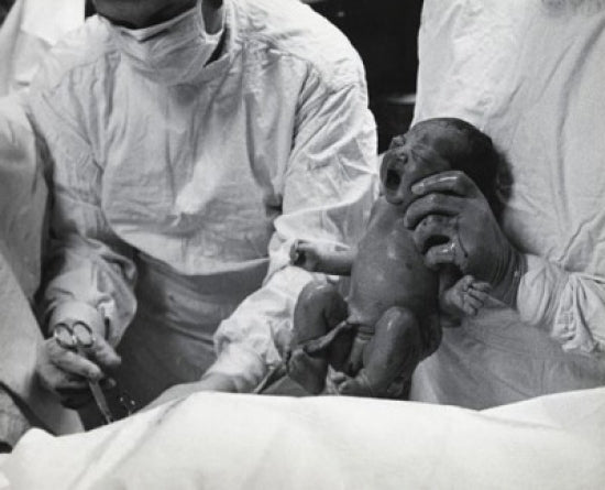 Midsection view of a doctor holding a newborn baby poster print.