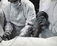 Midsection view of a doctor holding a newborn baby poster print.