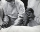 Midsection view of a doctor holding a newborn baby poster print.