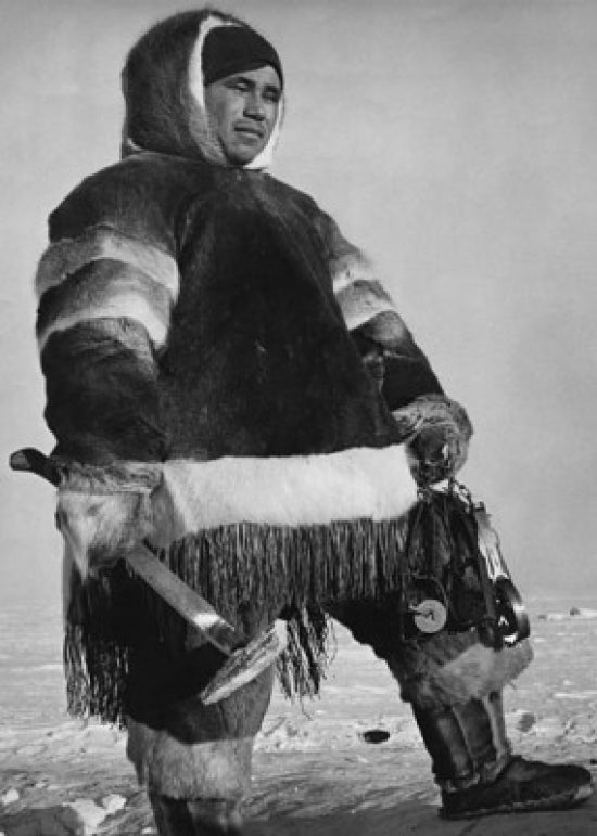 Eskimo man holding an axe in the Northwest Territories, Canada - Poster Print