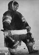 Eskimo man holding an axe in the Northwest Territories, Canada - Poster Print