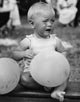Crying Baby Girl with Balloons Poster Print