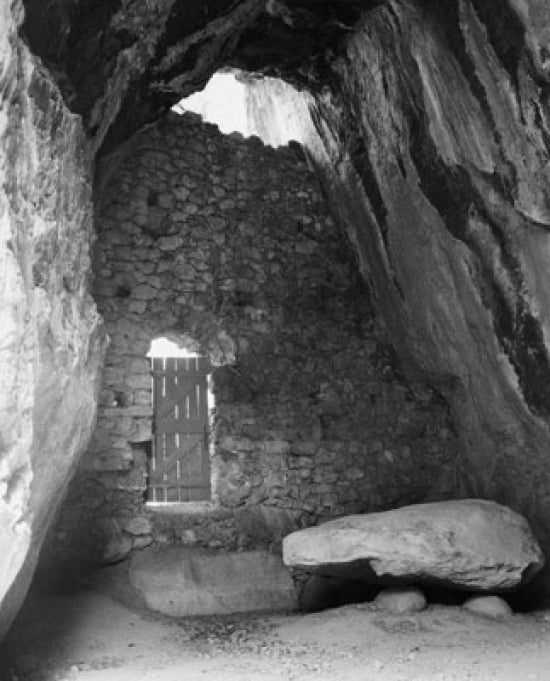 Door in a Stone Wall Poster Print showcasing unique architectural design