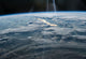 Sun Glint from the International Space Station Poster Print showcasing Earth's landscapes illuminated by sunlight.