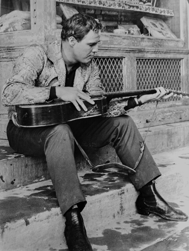 Marlon Brando playing guitar in a scene from The Fugitive Kind photo print.