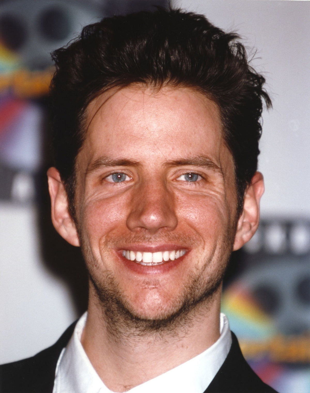 Close-up portrait photo print of Jamie Kennedy in a black suit and white shirt.