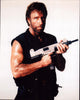 Chuck Norris holding a gun in Delta Force 2 photo print.