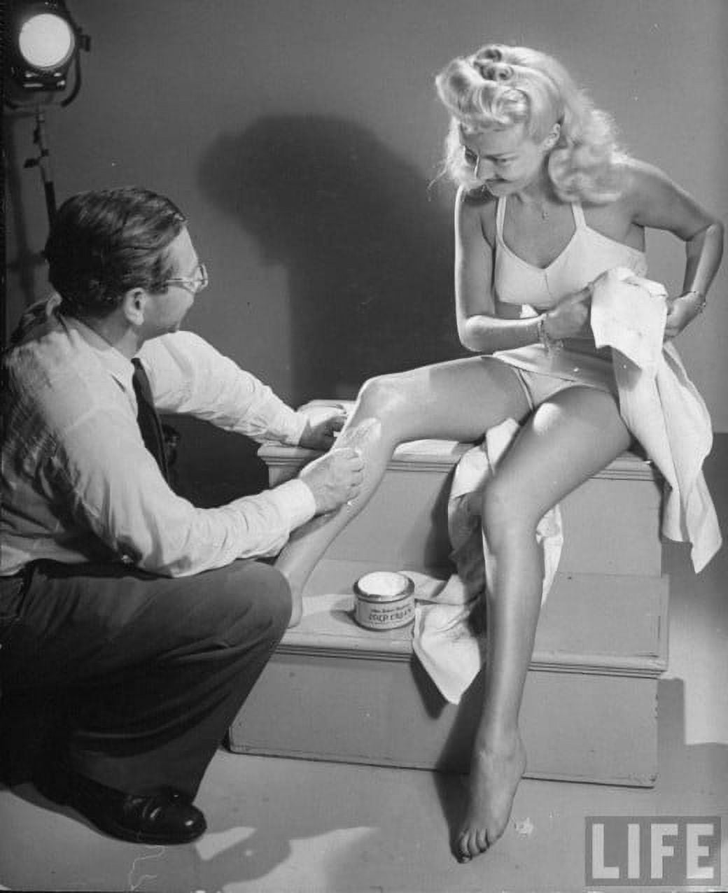 Betty Grable shaving photo print showcasing classic Hollywood glamour.