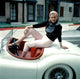 Vintage photo poster print of Anita Ekberg with her Jaguar from the late 1950s.
