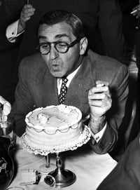 Irving Berlin blowing out candles photo print on premium paper.