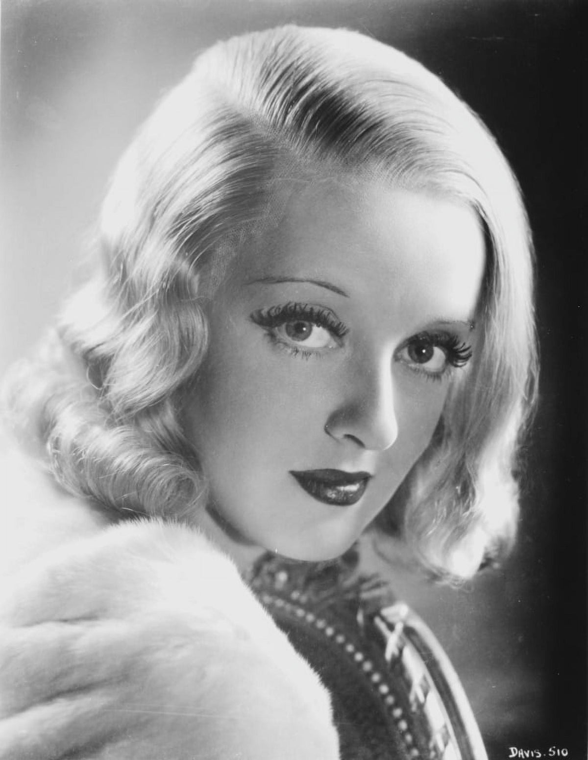 Bette Davis portrait photo print in white fur coat and black underclothes.