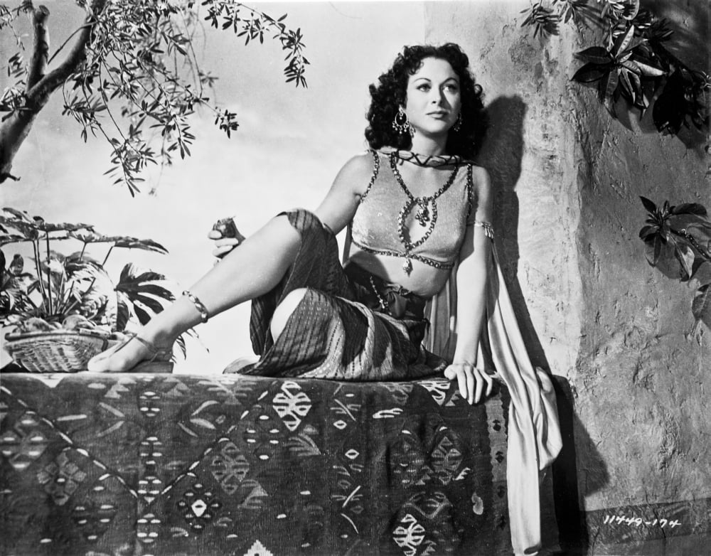 Hedy Lamarr wearing a costume sitting outdoors photo print