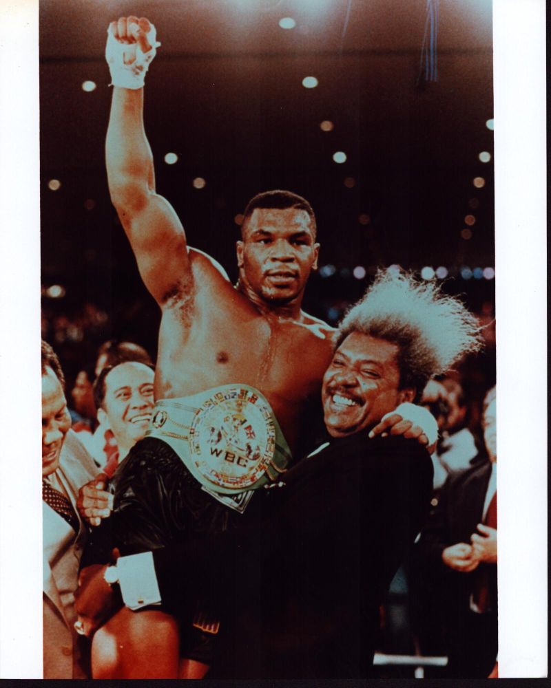 Don King holding Mike Tyson wearing a championship belt photo print.